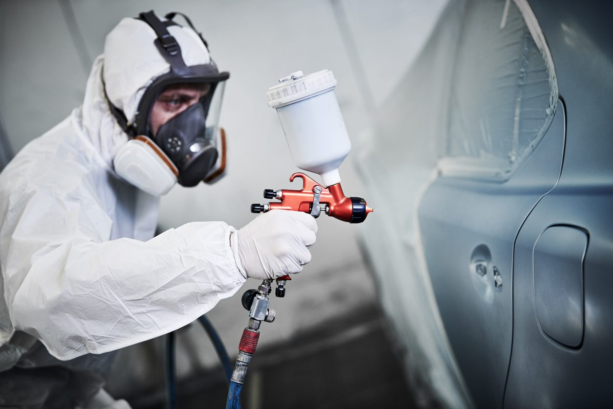 Mill Pond painter spraying refinish coat